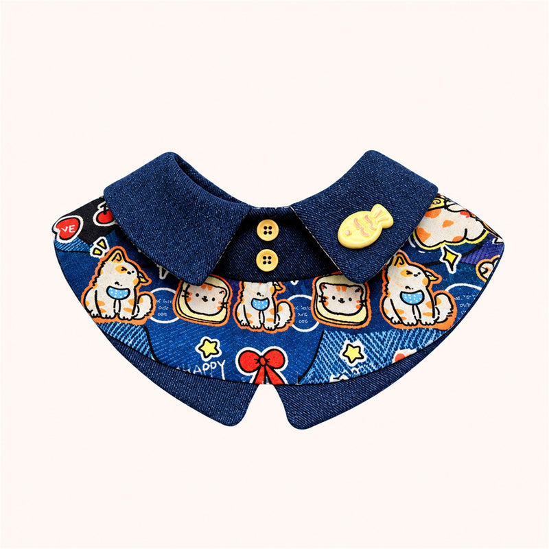 AI-cleaned product photo: Kitten & Fish big bow pet bib, navy collar with kitten-and-fish print and a little fish pin