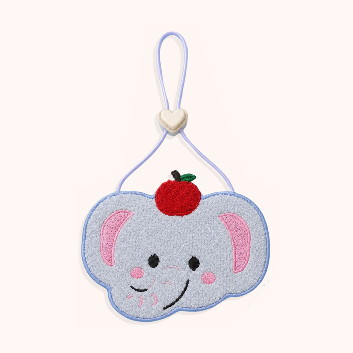 AI-cleaned product photo: Apple Elephant pet bib, grey elephant face with a red apple on a soft cord