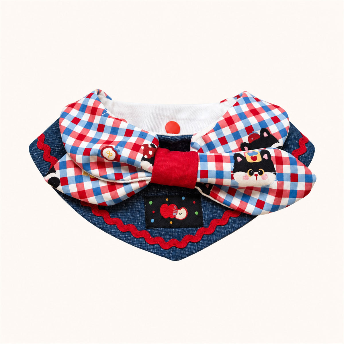 AI-cleaned product photo: Apple Cat big bow pet bib, blue-and-red check bow with a little cat patch