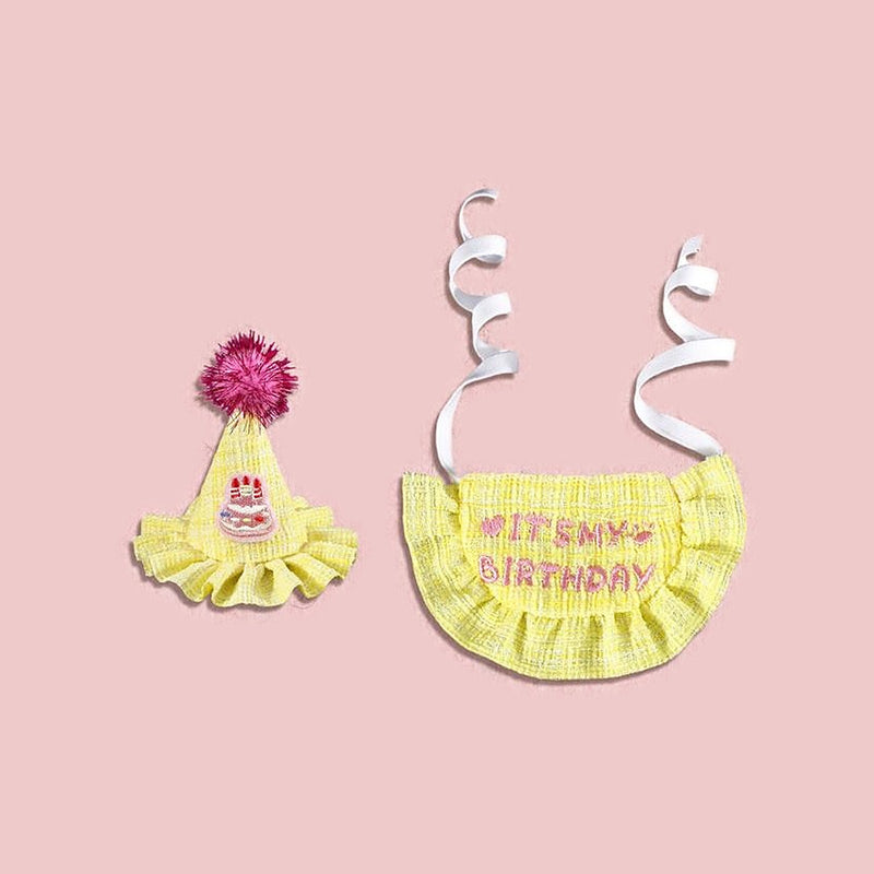 Product photo: Yellow Birthday Party Hat & Bib Set — Yellow tweed party hat with a sparkly pom-pom and an embroidered cake, plus a ruffled “It's my birthday” bib.