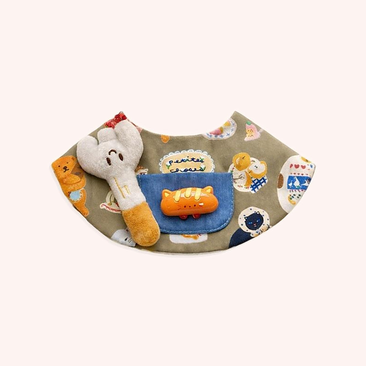 Product photo: Little Bun Pet Bib — Olive bakery-print bib with a denim pocket, a plush bunny and a tiny bread-loaf charm.