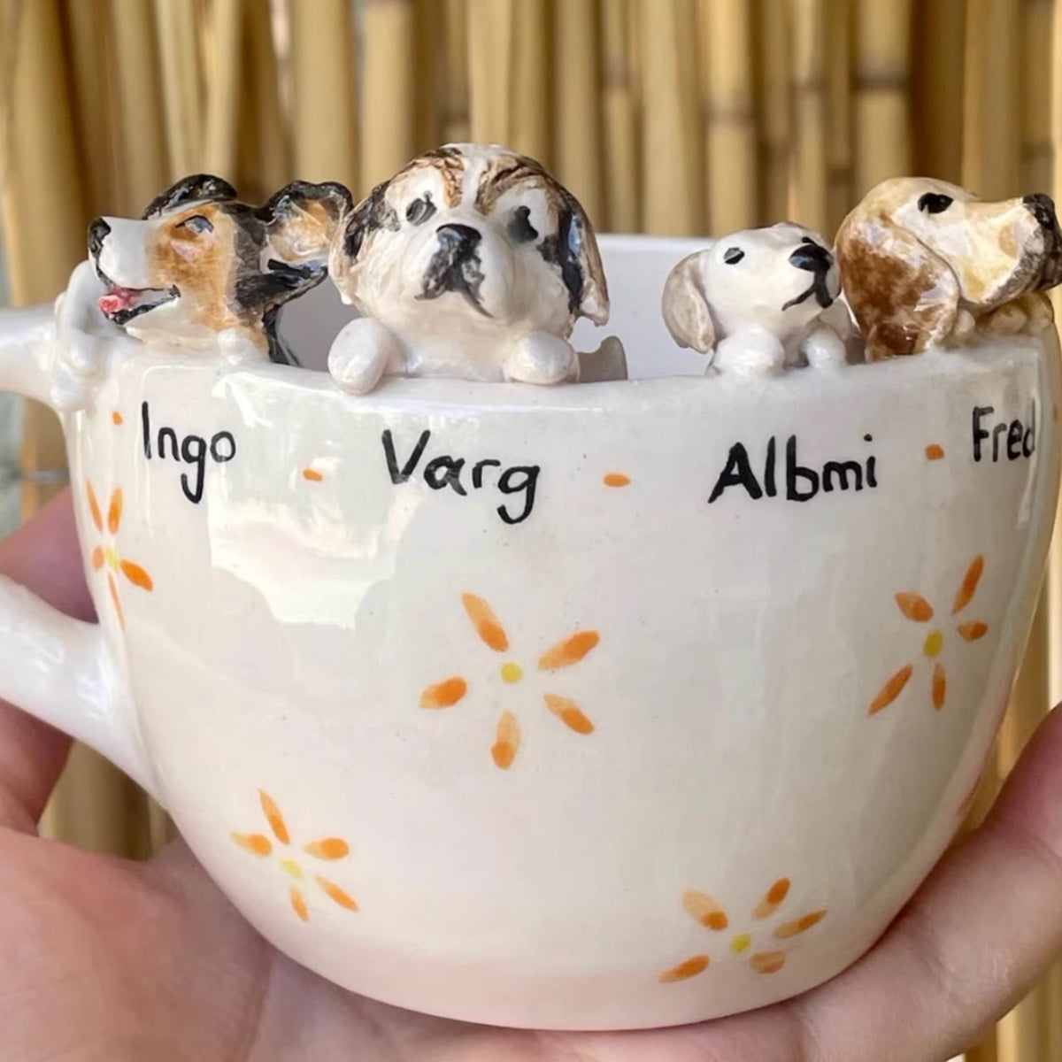 AI-cleaned product photo: custom mug with four hand-sculpted dogs and their names