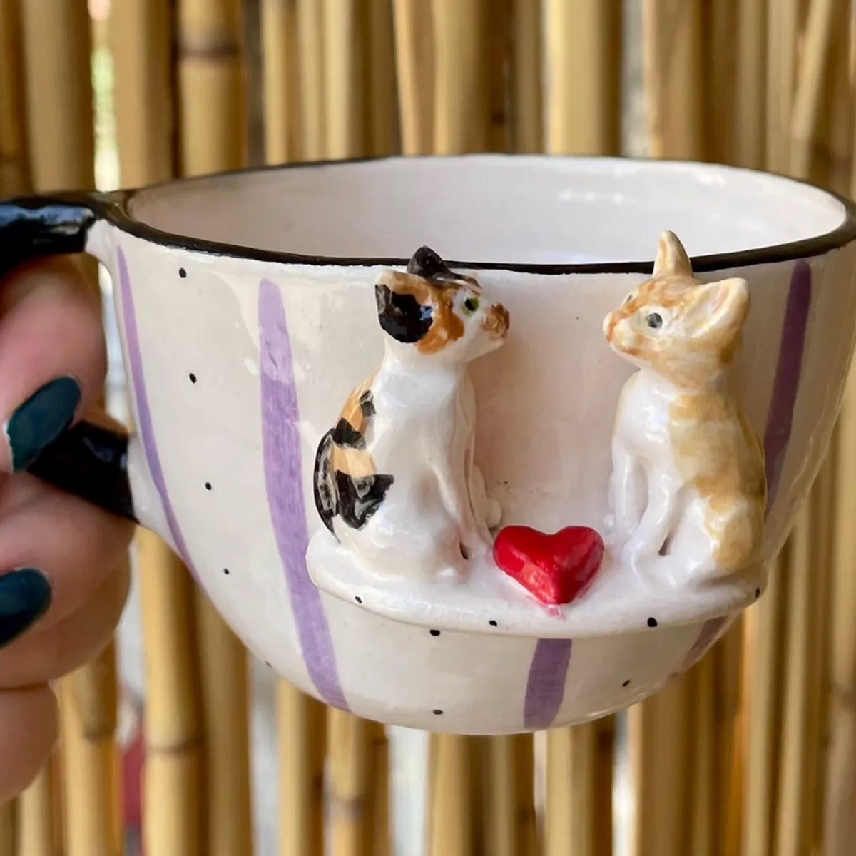 AI-cleaned product photo: custom mug with two hand-sculpted cats and a red heart